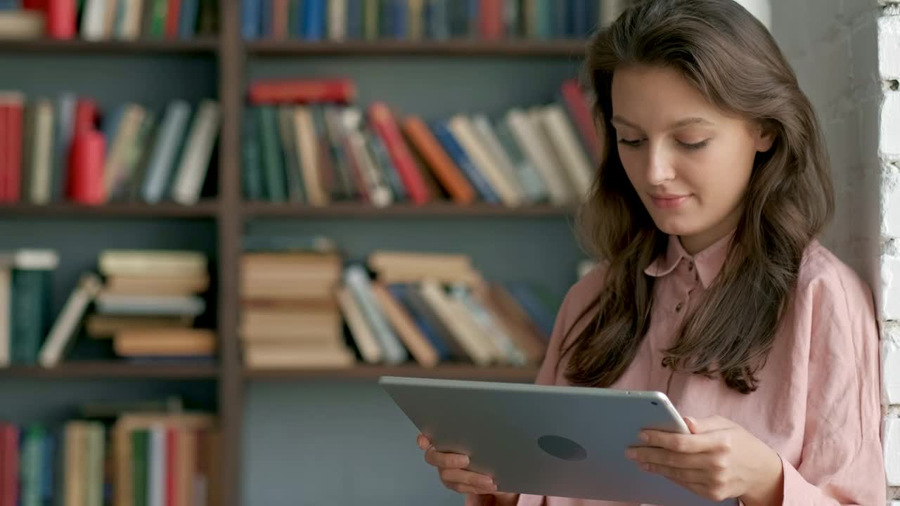 Free Video Stock Student Reading On A Tablet At A Library Live Wallpaper - Free Download