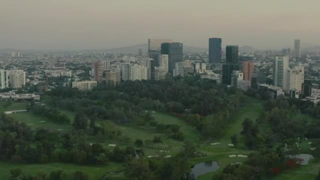 Stock Video Mixkit Flying Over A Large Park Surrounded By A Metropolis Smal Live Wallpaper For PC - Free Download