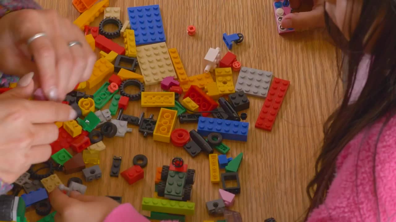 Stock Video Hands Of A Mother And Daughter Playing With Legos Animated Wallpaper - Free Download