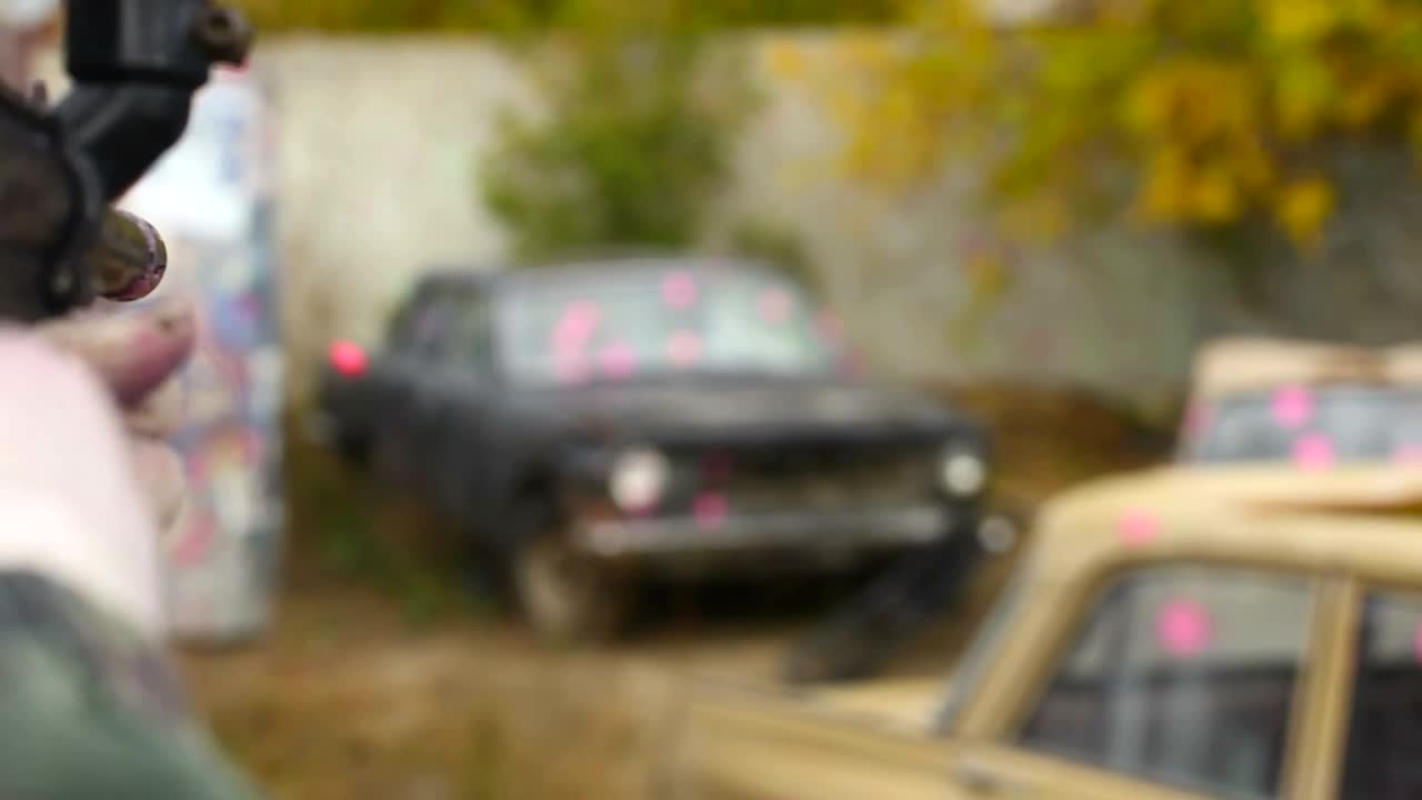 Stock Video Man Shooting Paintballs To An Old Ca Animated Wallpaper - Free Download