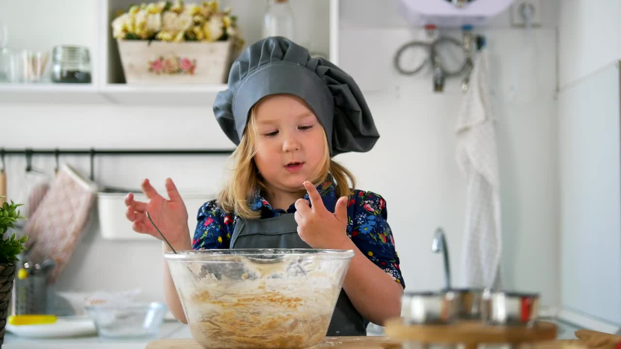 Stock Video Little Girl In A Kitchen Stirring A Cookie Mix Animated Wallpaper - Free Download