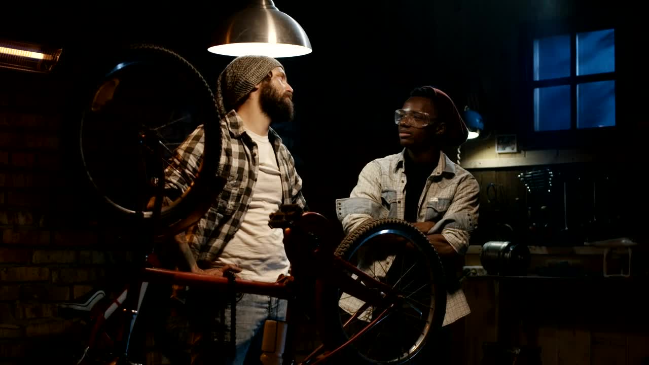 Free Video Stock tow young man talking in a bicycle repair shop Live Wallpaper - Free Download