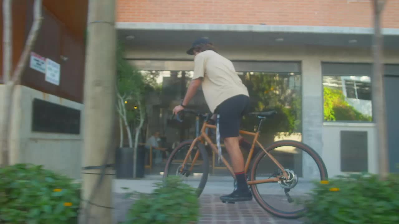 Stock Video Man Cycling Down A Street In A City Animated Wallpaper - Free Download