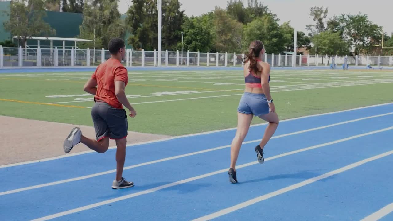 Stock Video Pair Of Man And Woman Athletes Running On A Track Live Wallpaper - Free Download