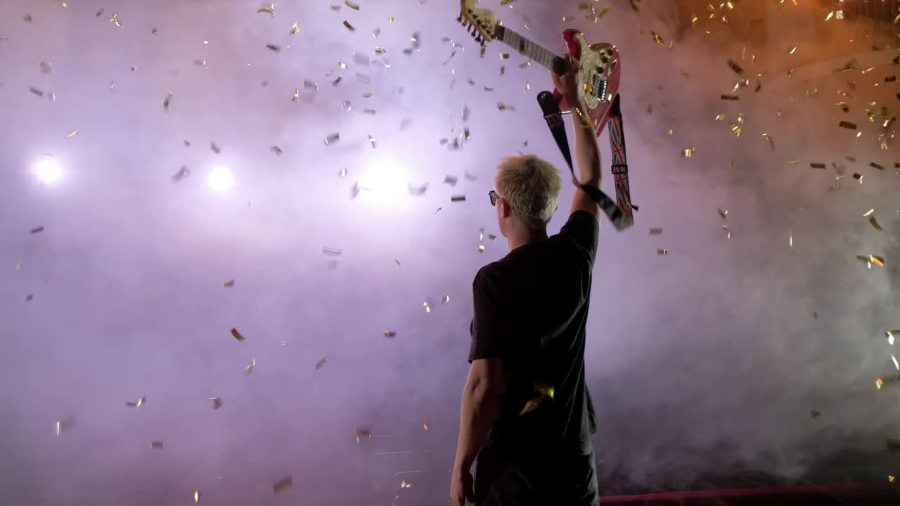 Stock Video Guitarist Raising His Guitar On A Smoky Stage Live Wallpaper For PC - Free Download