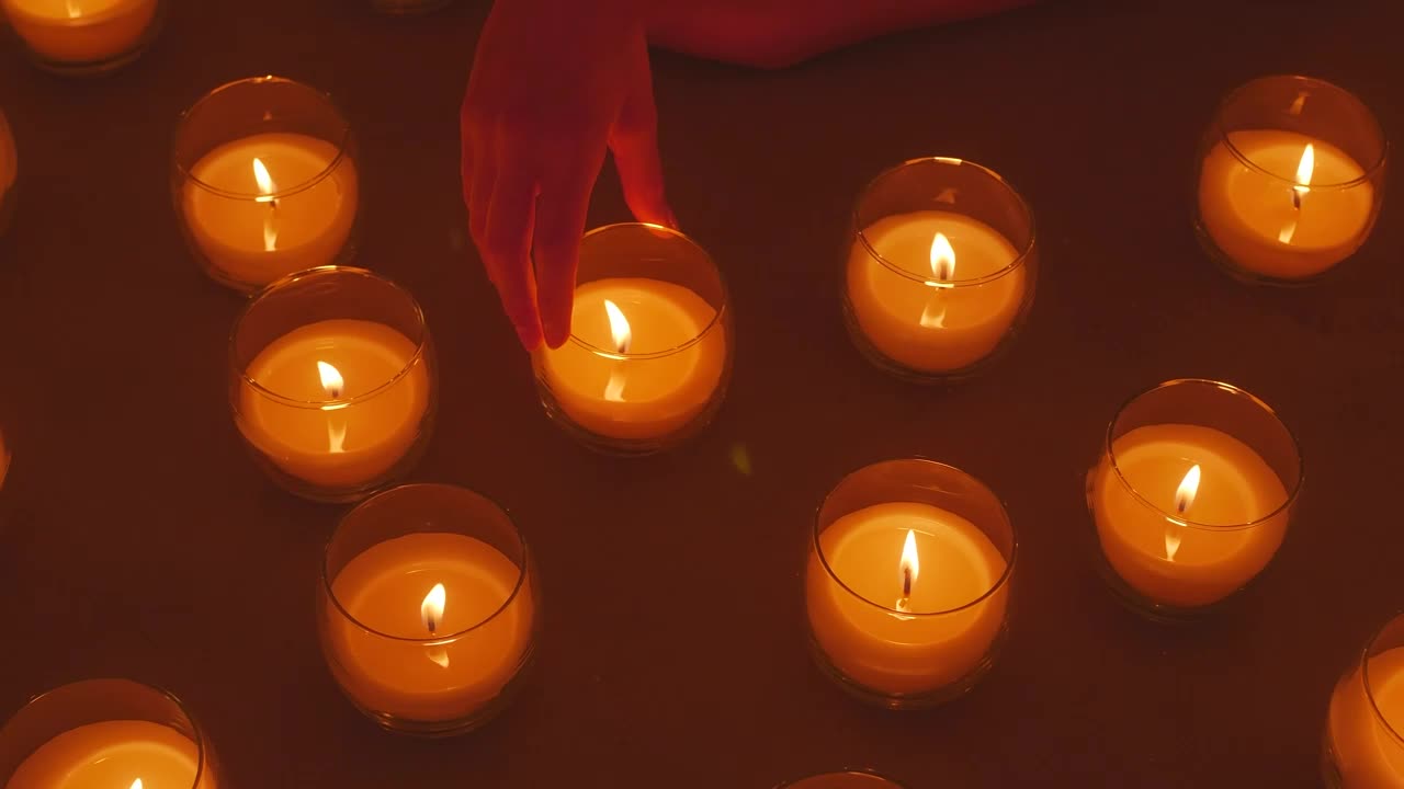Stock Video Hand Of A Lady Arranging Burning Candles Live Wallpaper For PC - Free Download