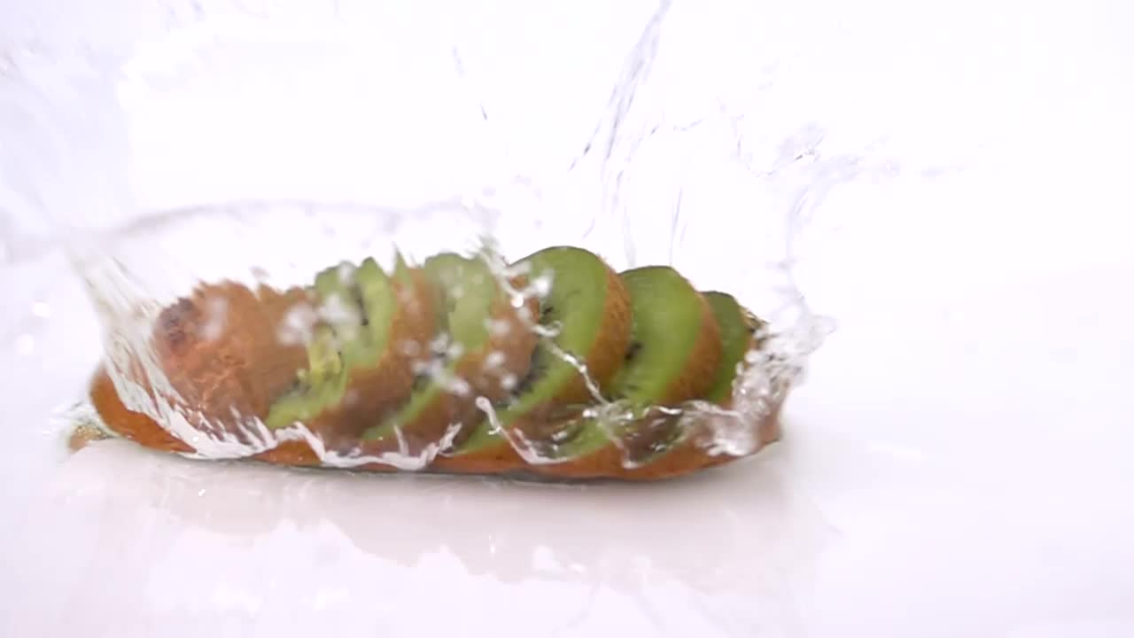 Stock Video Kiwi Sliced Into Slices Falling On Water Animated Wallpaper - Free Download
