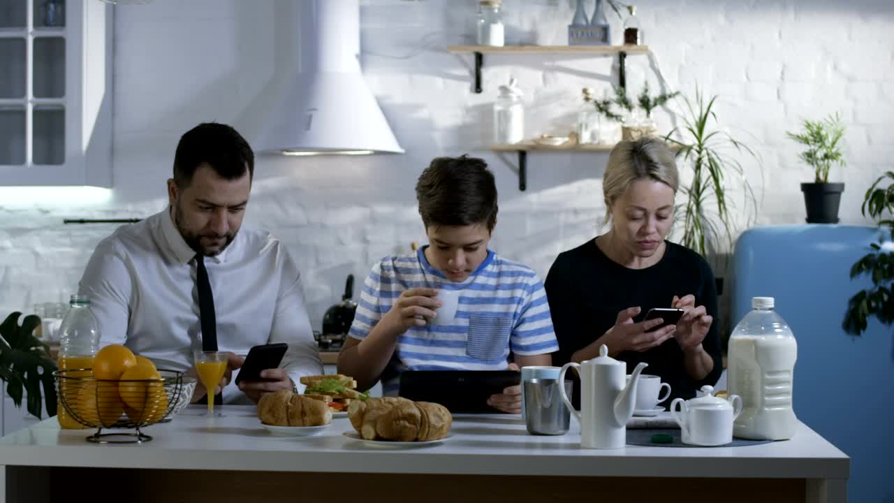 Stock Video Family At Breakfast Watching Their Smartphones Live Wallpaper For PC - Free Download