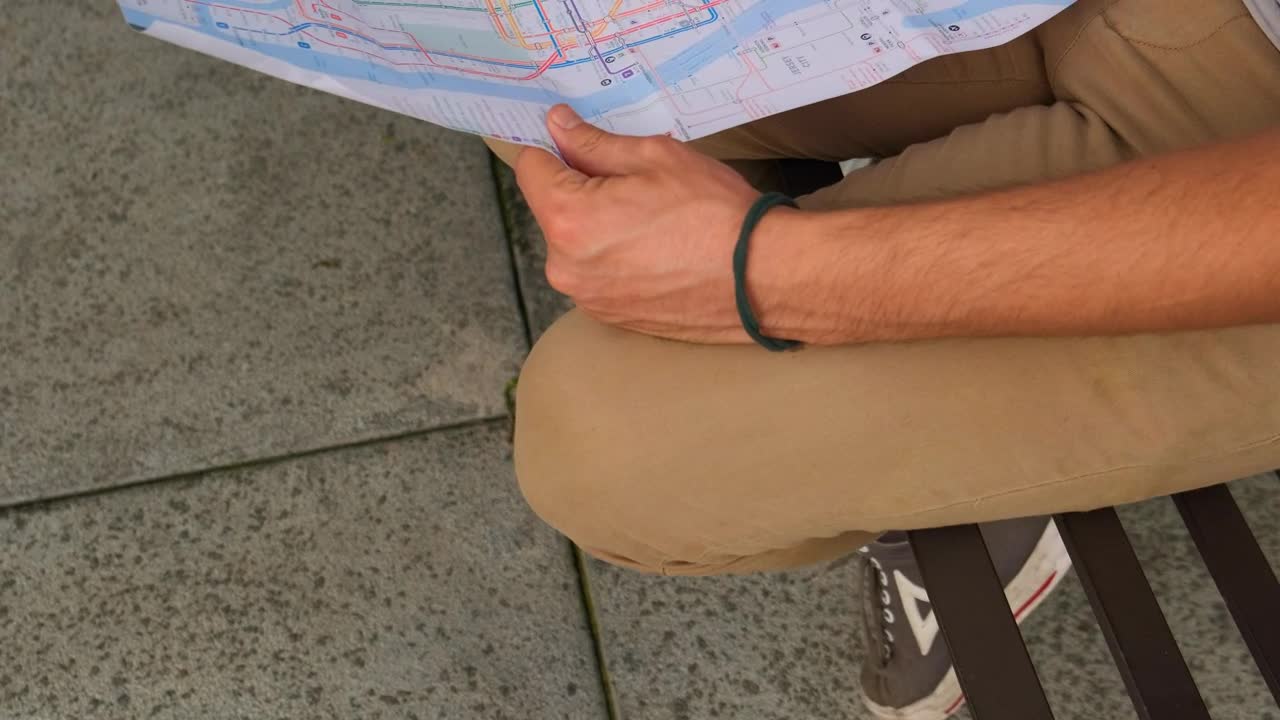 Stock Video People Sitting On The Street Reviewing A Map Together Live Wallpaper - Free Download