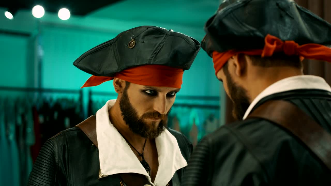 Stock Video Man In A Pirate Costume Grimacing To The Mirror Animated Wallpaper - Free Download