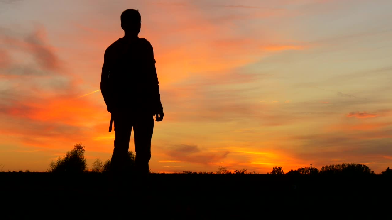 Free Stock Video Silhouette Of A Man With A Backpack In The Sunset Live Wallpaper - Free Download