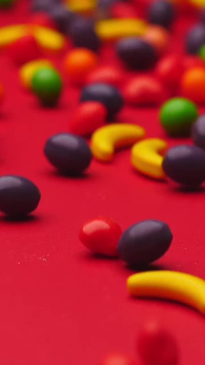 Stock Video Fruit Shaped Sweets Rolling On A Red Surface Live Wallpaper For PC - Free Download