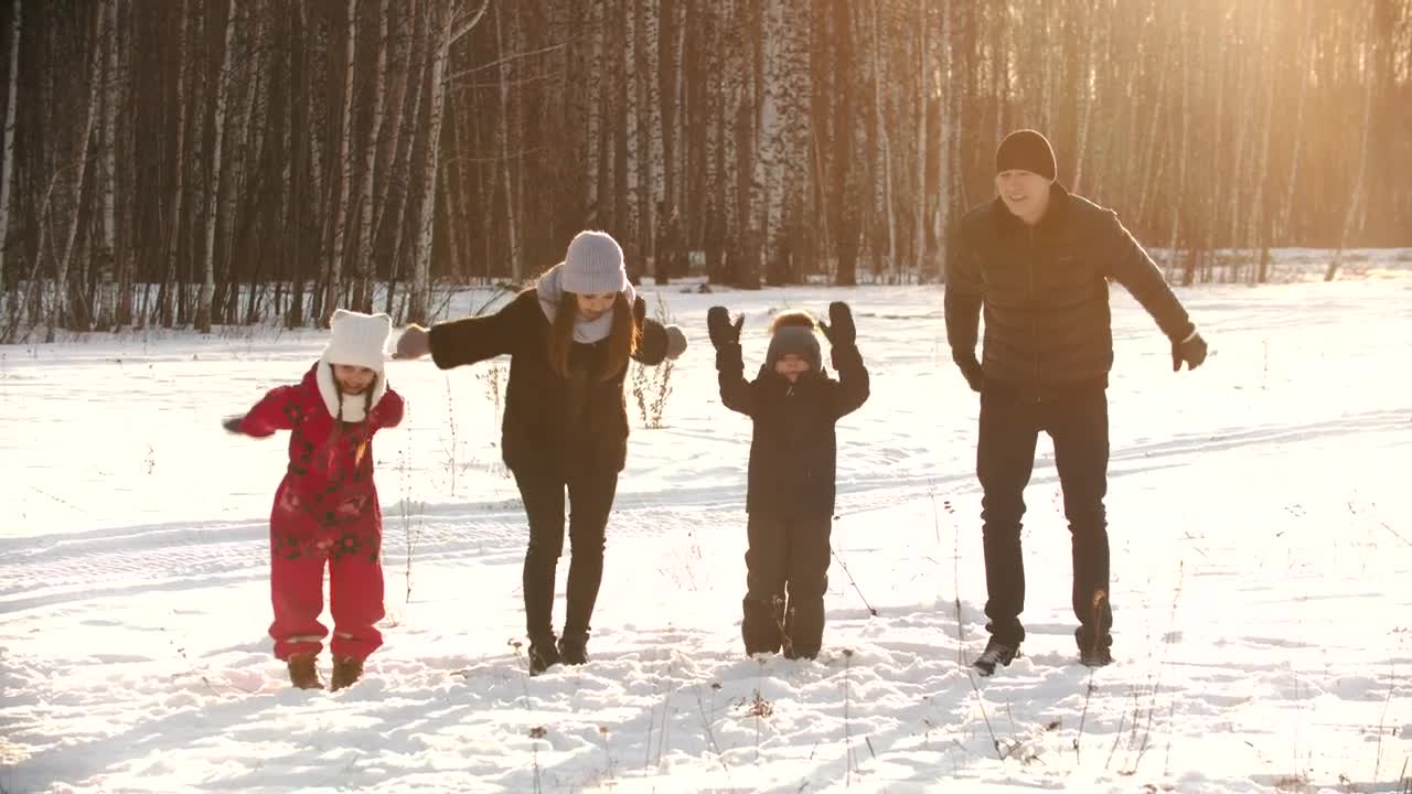 Stock Video Happy Family Jumps In The Snow In A Forest Animated Wallpaper - Free Download