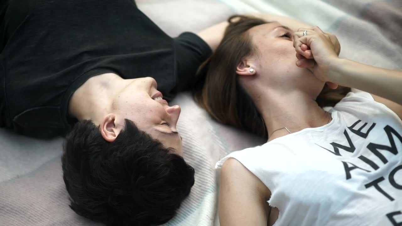 Stock Video Lgbtq Couple Talk And Kiss Lying Opposite On Bed Animated Wallpaper - Free Download