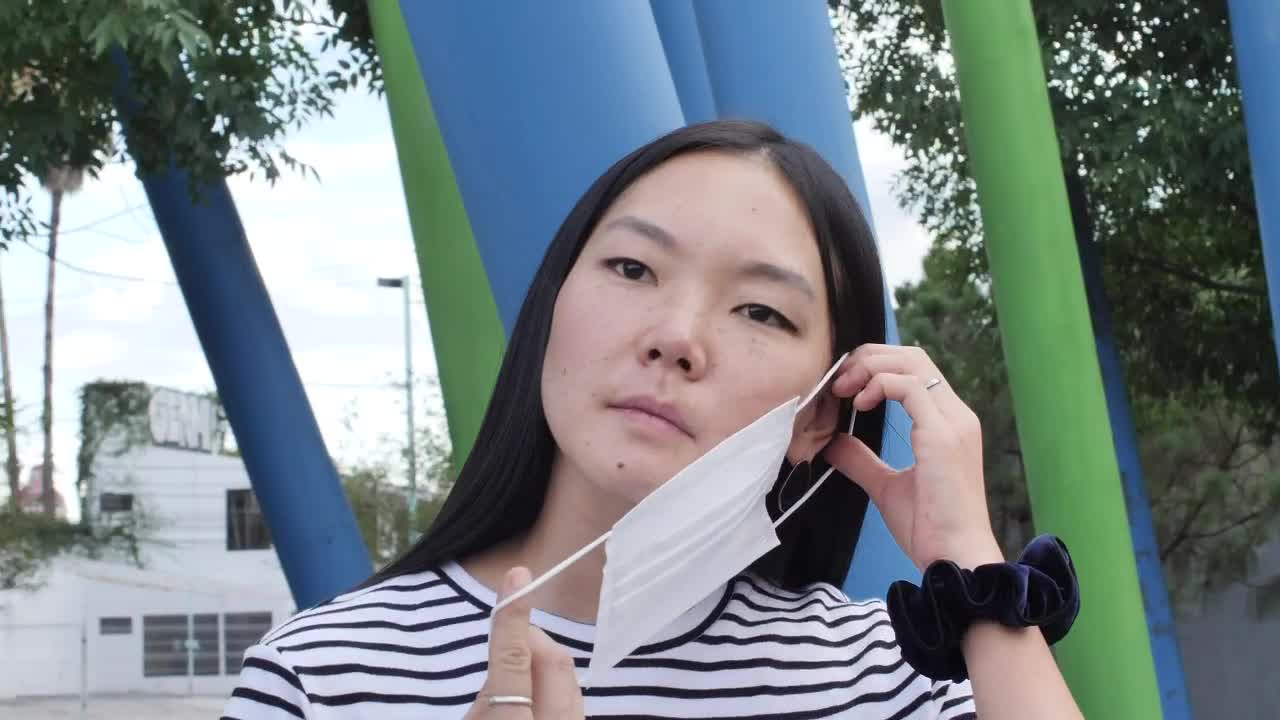 Stock Video Girl Putting On A Mask In The Middle Of The Live Wallpaper For PC - Free Download
