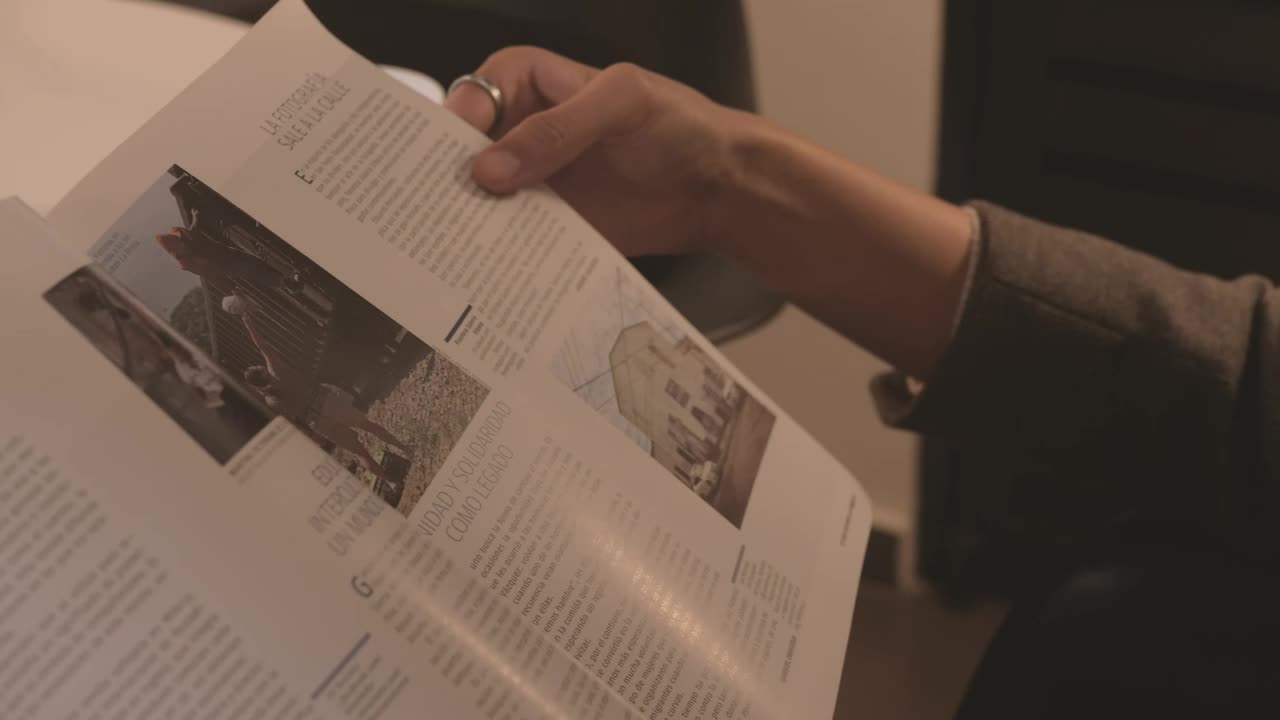 Stock Video Hands Of A Woman Slowly Leafing Through A Magazine Animated Wallpaper - Free Download