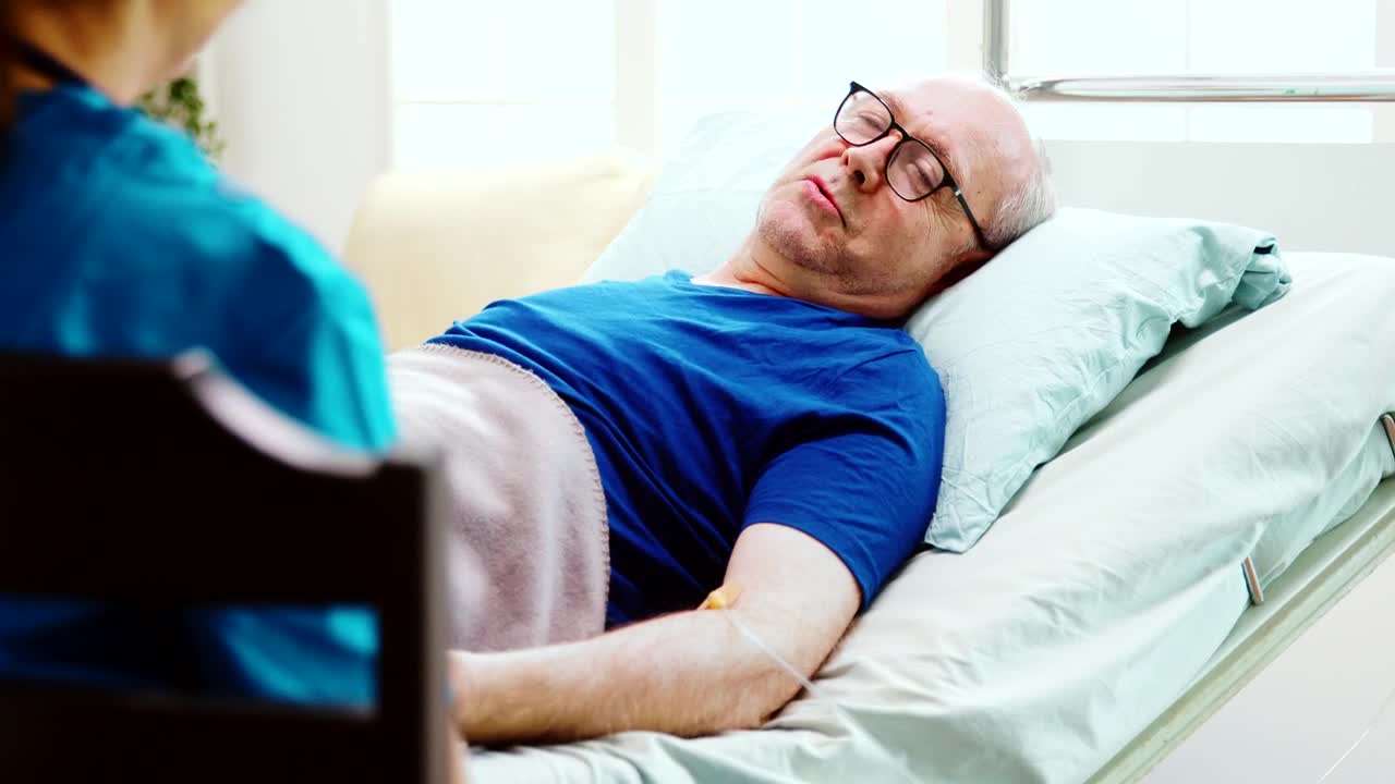 Stock Video Elderly Man Chats With Home Care Nurse While Laying In Live Wallpaper For PC - Free Download