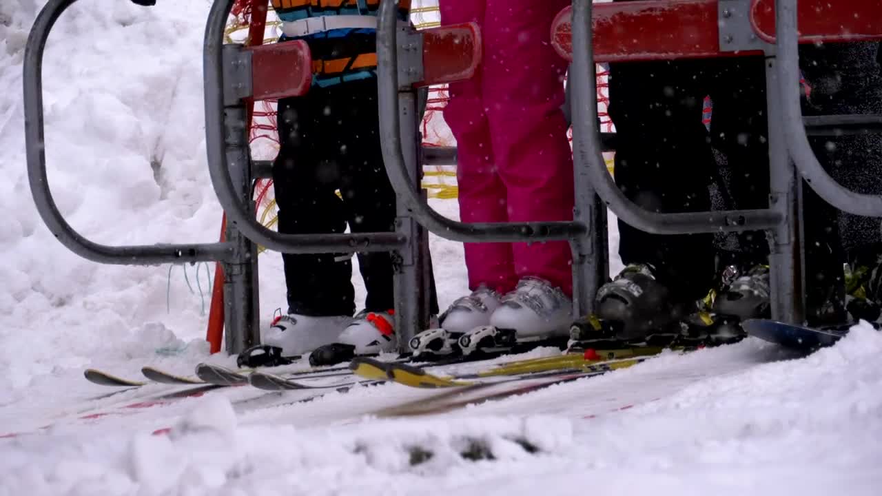 Free Video Stock the skiers getting ready to board the ski lift Live Wallpaper - Free Download