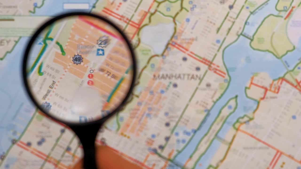 Stock Video Observing With A Magnifying Glass On A Map Of Manhattan Live Wallpaper - Free Download