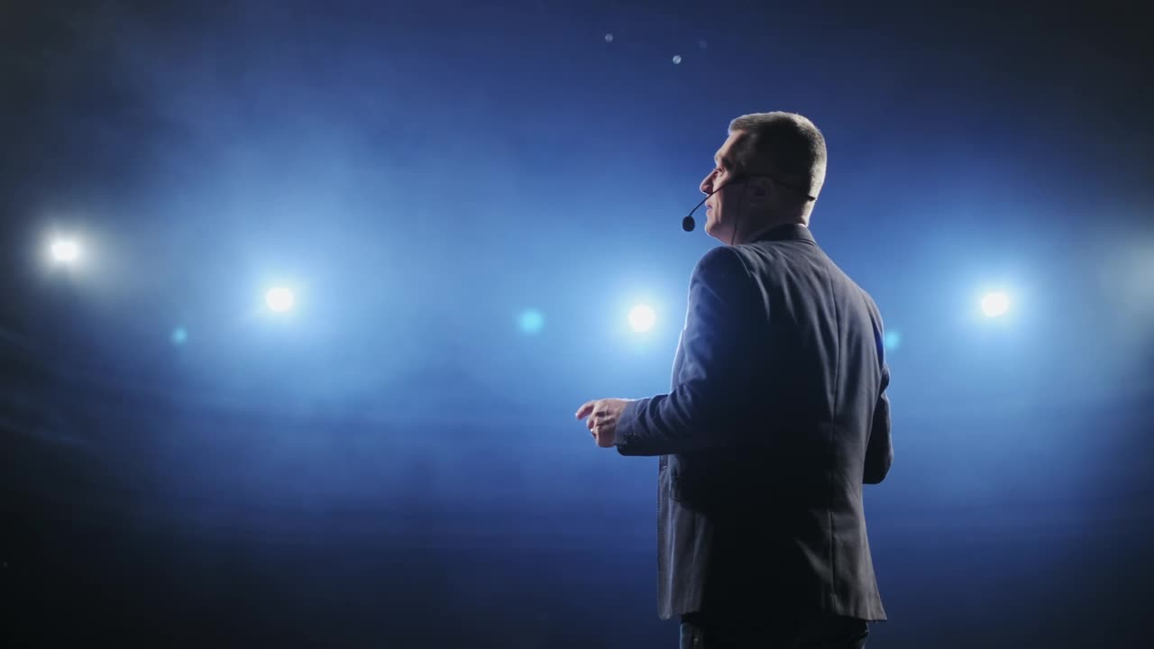 Stock Video Male Speaker Giving A Talk At A Stage Animated Wallpaper - Free Download