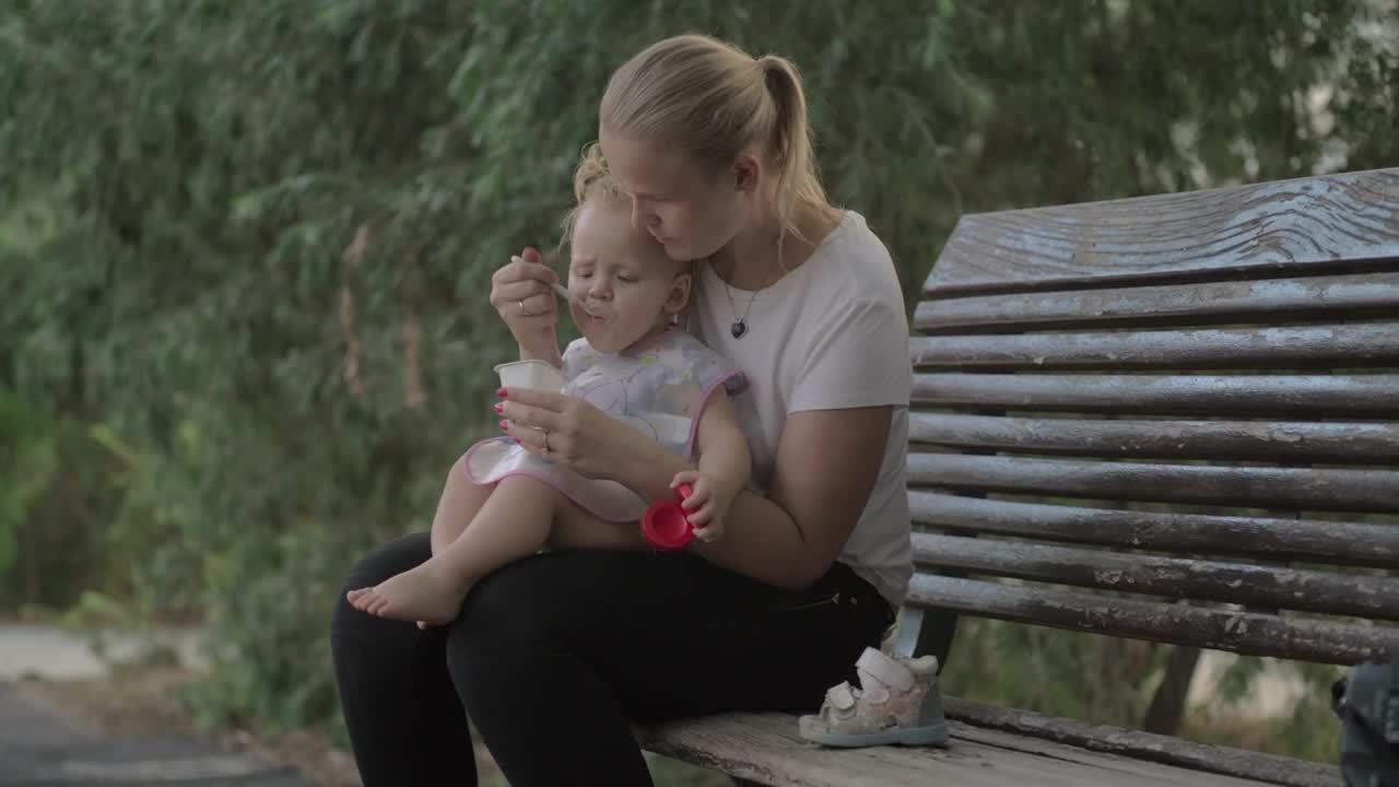 Stock Video Feeding Her Young Child A Yogurt Live Wallpaper For PC - Free Download