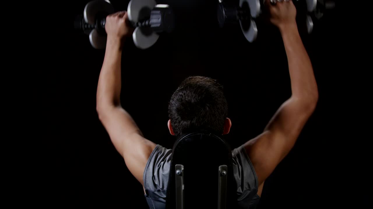Stock Video Lifting Weights Against A Dark Background Animated Wallpaper - Free Download