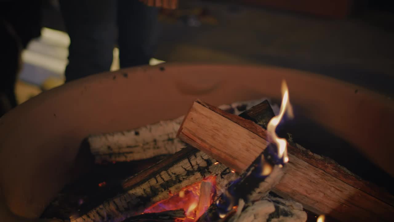 Stock Video Man Putting Firewood For A Campfir Animated Wallpaper - Free Download