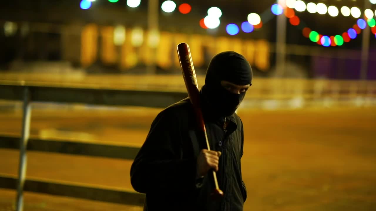 Free Video Stock thug with balaclava walking with a bat Live Wallpaper - Free Download