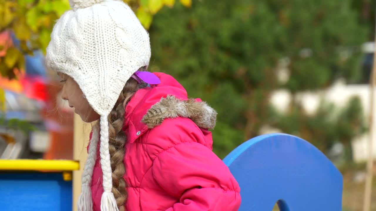 Stock Video Little Girl With A Winter Hat On The Playground Animated Wallpaper - Free Download