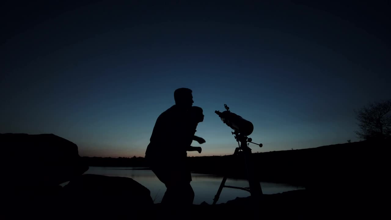 Stock Video Man And A Boy You Using The Telescope At Dusk Animated Wallpaper - Free Download