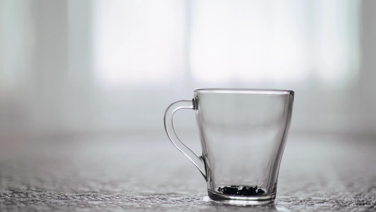 Free Video Stock teapot pouring tea into clear glass grabbed by hand Live Wallpaper - Free Download