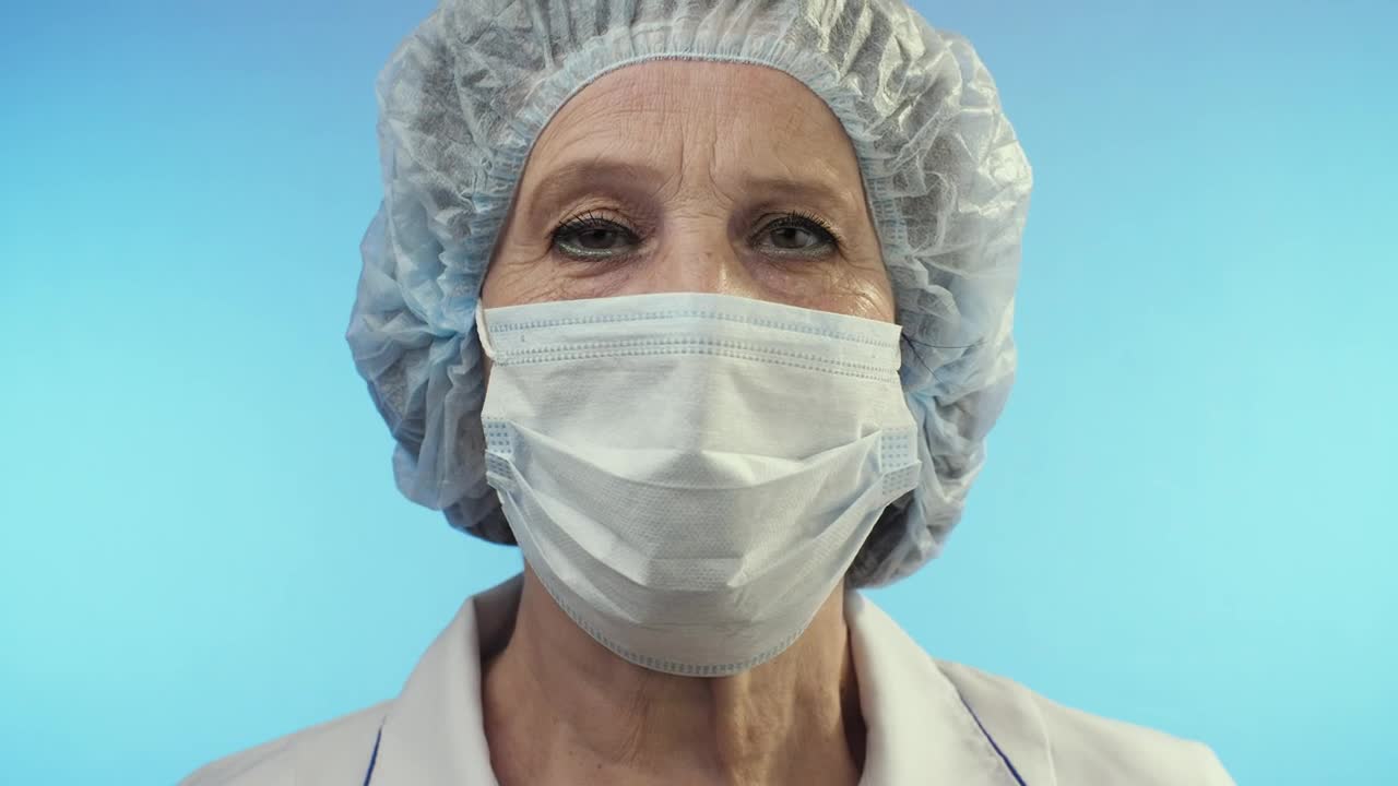 Stock Video Old Female Doctor Wearing Face Shield From Surgery Live Wallpaper - Free Download