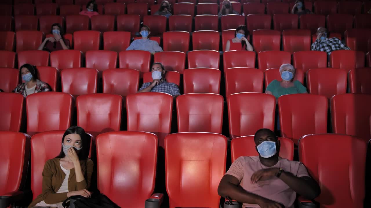 Stock Video People With Masks Watching A Movie In A Cinema Live Wallpaper - Free Download