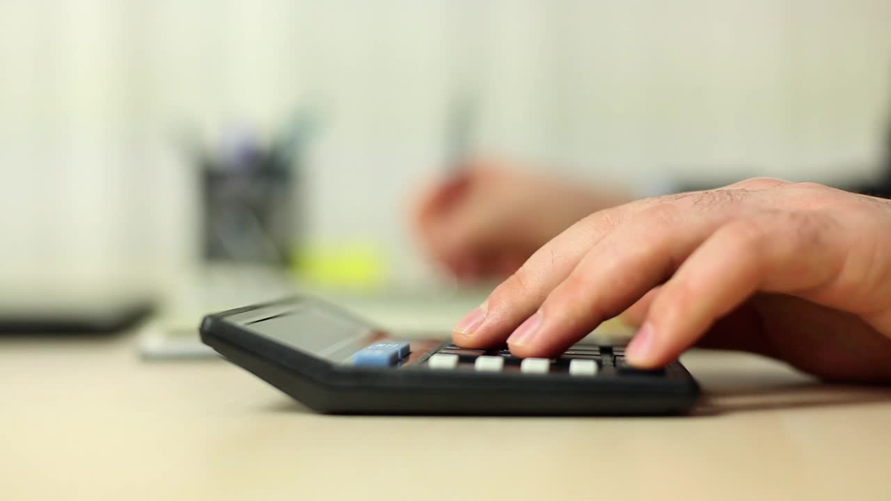 Stock Video Person Doing Calculations With A Calculator Live Wallpaper - Free Download
