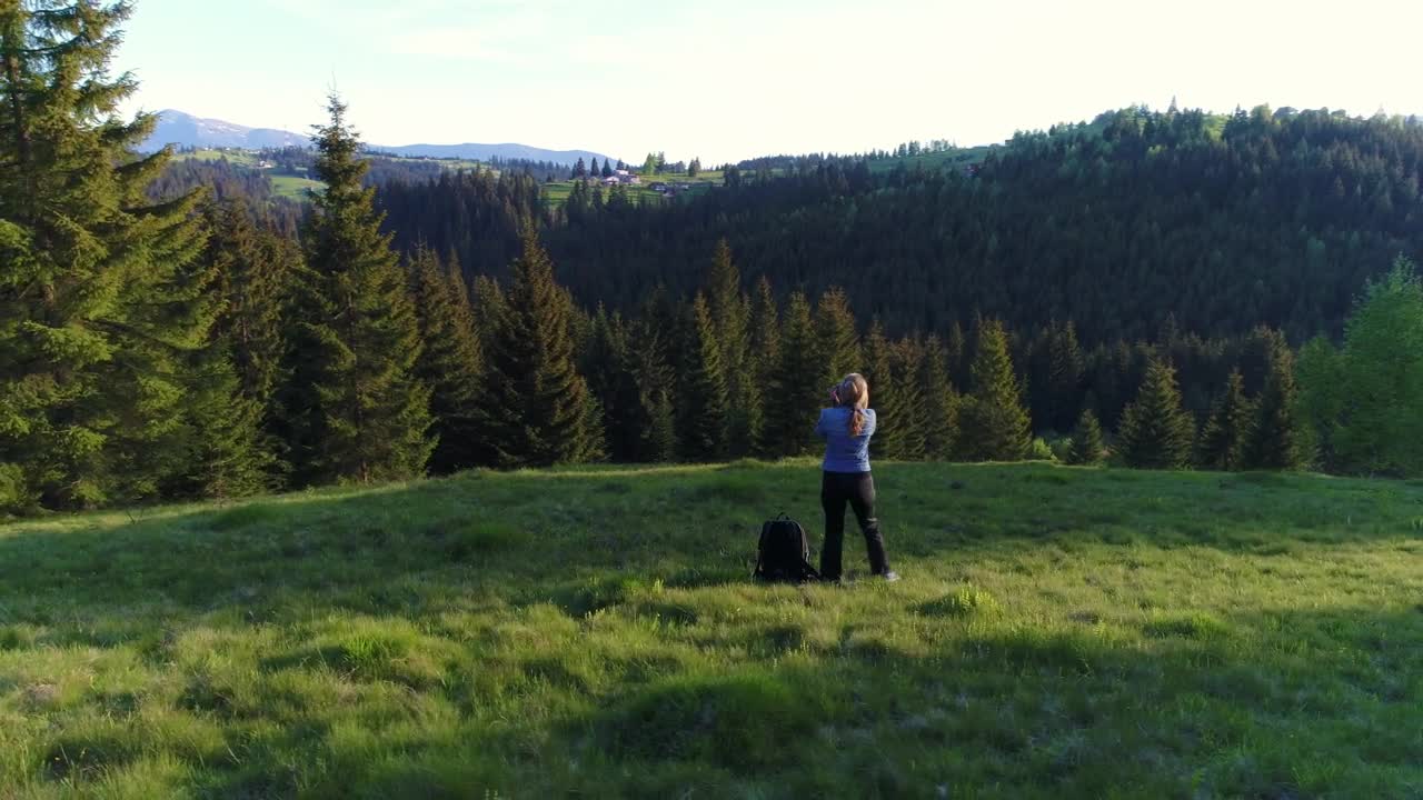 Stock Video Female Photographer Taking Pictures In A Forest Meadow Live Wallpaper For PC - Free Download