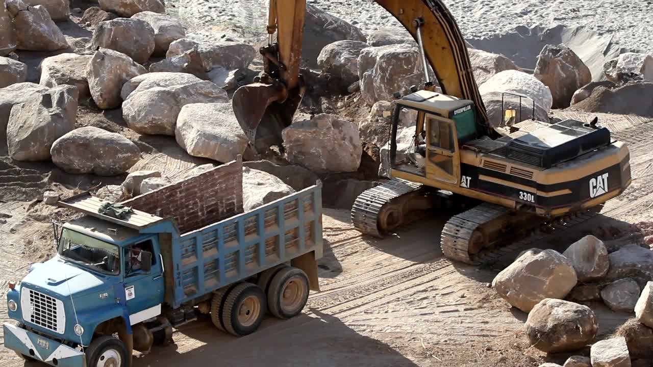 Stock Video Excavation Crane Lifts A Rock Into A Truck Live Wallpaper For PC - Free Download