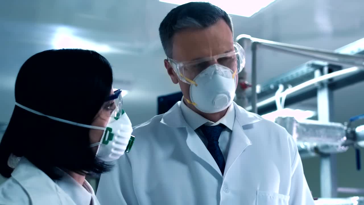 Free Stock Video Scientists Wearing A Face Mask Talking In The Lab Live Wallpaper - Free Download