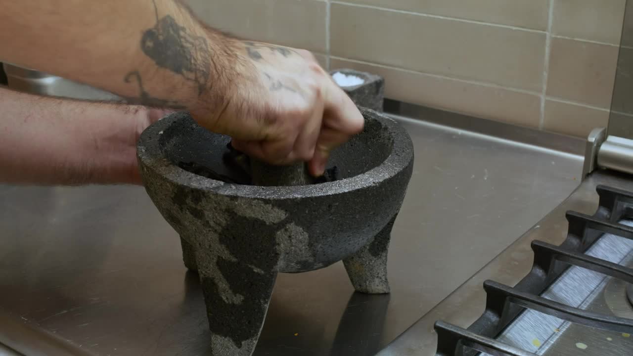 Stock Video Cook Grinding Chilies In A Molcajete Live Wallpaper For PC - Free Download