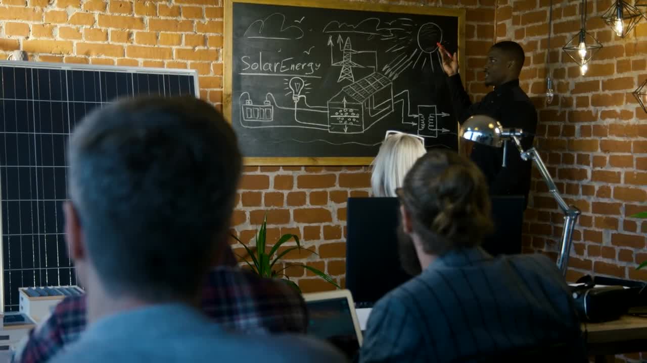 Stock Video Man Presenting Solar Technology To Small Audienc Animated Wallpaper - Free Download