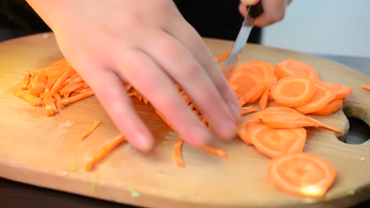 Stock Video Hands Of A Person Chopping Carrots On A Board Animated Wallpaper - Free Download