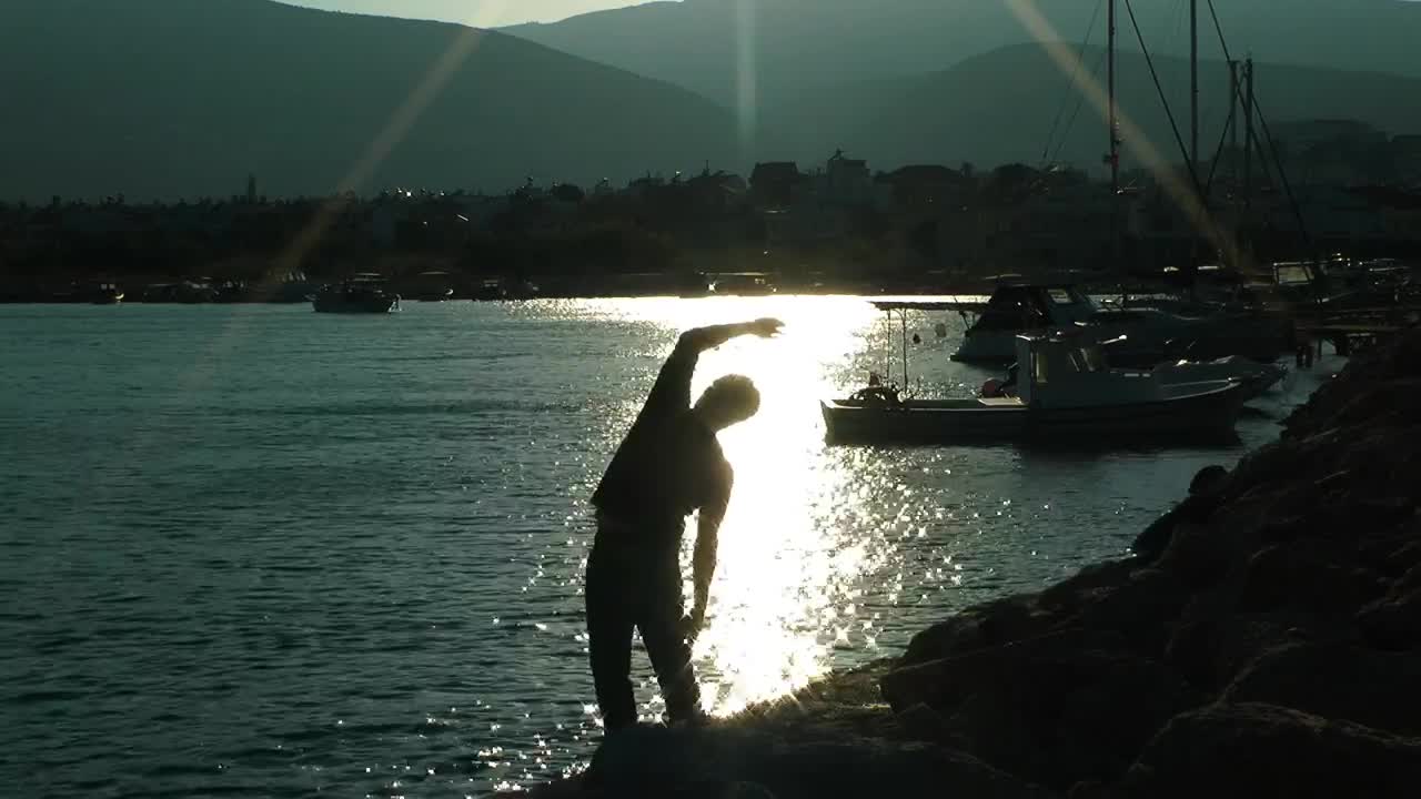 Stock Video Man Doing Stretching In Port At Sunrise Animated Wallpaper - Free Download