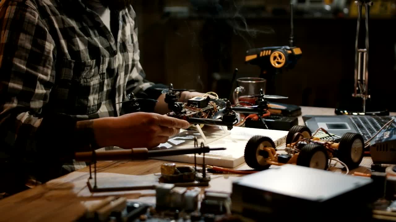 Stock Video Man Working On Repairing Drone Circuit Animated Wallpaper - Free Download