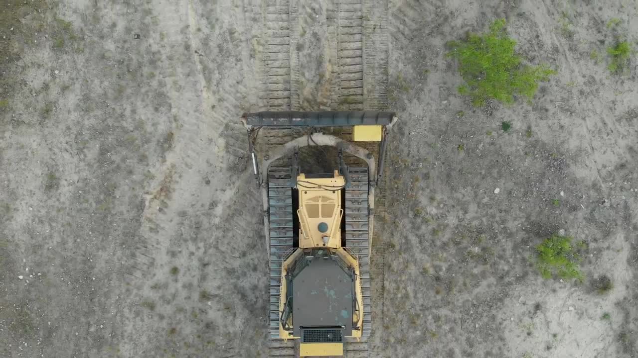 Free Video Stock tracked bulldozer driving on a sandy road Live Wallpaper - Free Download