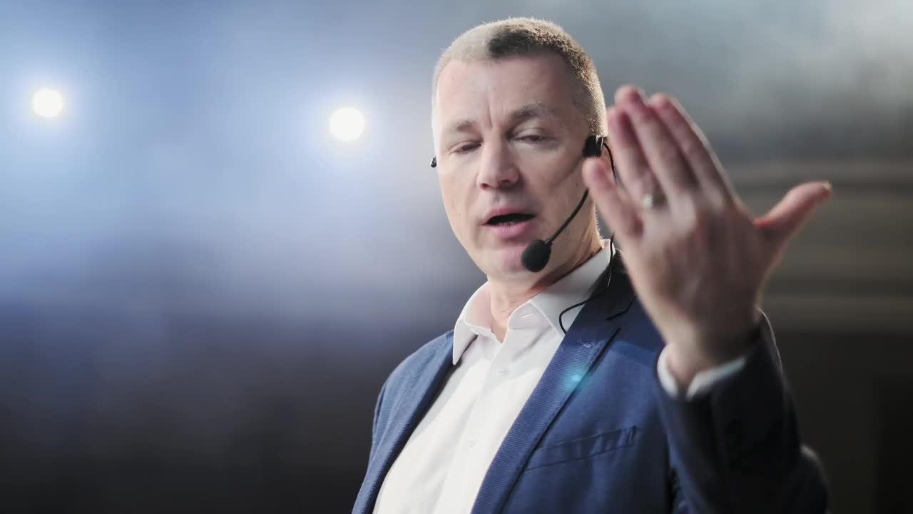 Video Stock Closeup Of Conference Speaker On Stage Gesturing At Camera Live Wallpaper For PC - Free Download
