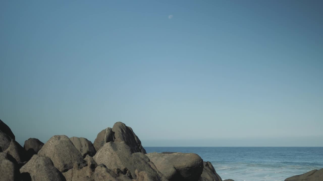 Stock Video Man With Surfboard Stands On Boulder Animated Wallpaper - Free Download
