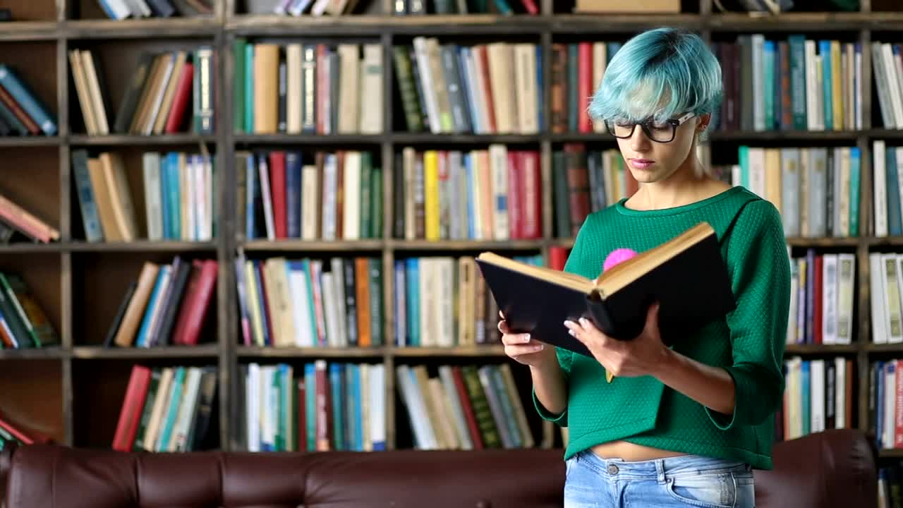 Stock Video Girl With Glasses Reading A Book In A Library Live Wallpaper For PC - Free Download