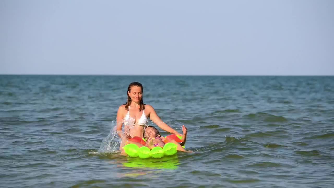 Stock Video Mother Playing With Her Daughters On A Floaty In Th Animated Wallpaper - Free Download