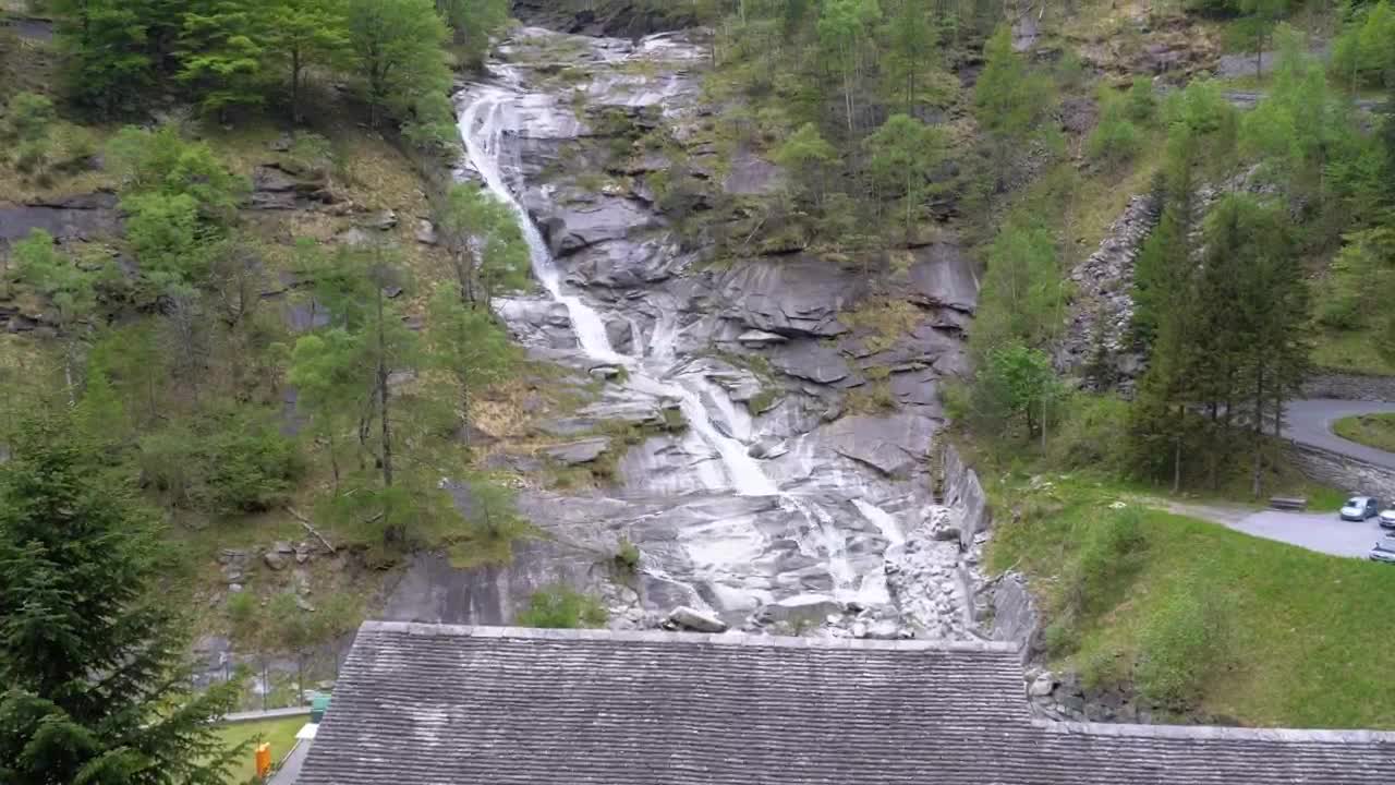 Stock Video Low View Of A Waterfall On A Forested Mountain Animated Wallpaper - Free Download