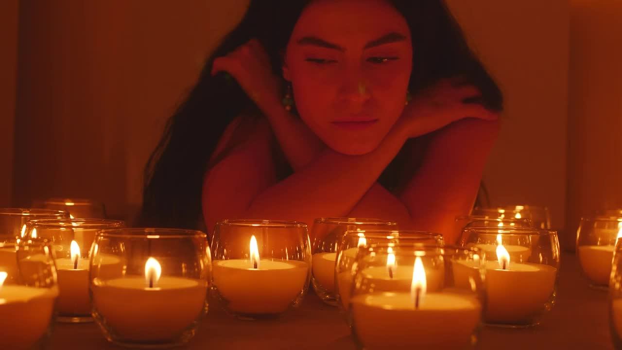 Stock Video Pensive Woman In The Dark Surrounded By Burning Candles Live Wallpaper - Free Download