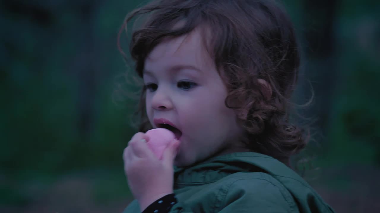 Stock Video Little Girl In Nature Eating A Marshmallow Animated Wallpaper - Free Download